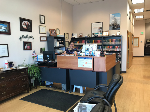 Office reception with a smiling employee.