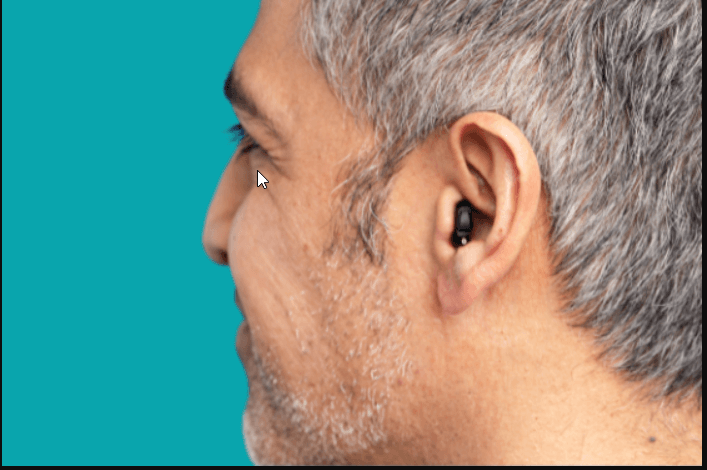 Two hearing aids placed on a table.