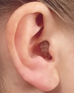 Ear with a hearing aid device inserted.